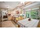 Cozy kitchen featuring wood cabinetry, countertops, tile flooring, and a large window at 6360 S Kendall St, Littleton, CO 80123
