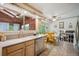 Bright kitchen with a skylight view to the exterior, stainless steel appliances, and dining area at 6360 S Kendall St, Littleton, CO 80123