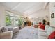 Spacious living room featuring large windows, vaulted ceilings, and neutral decor at 6360 S Kendall St, Littleton, CO 80123