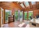 Bright sun room featuring skylights and hardwood flooring, with a view to the outdoors at 6360 S Kendall St, Littleton, CO 80123
