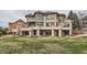 Spacious backyard with mature trees and multiple patios, offering ample outdoor entertaining opportunities at 2035 Buchanan Pt, Lafayette, CO 80026