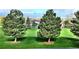 Backyard overlooking a golf course and mountain views, with lush trees at 2035 Buchanan Pt, Lafayette, CO 80026