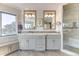 A bathroom features double sinks, grey cabinets, and a glass walk-in shower at 2035 Buchanan Pt, Lafayette, CO 80026