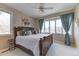 Inviting bedroom with a large window, a king-size bed, a ceiling fan, and lovely decor at 2035 Buchanan Pt, Lafayette, CO 80026
