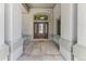 Inviting entrance highlighting a tiled floor, stylish columns, elegant front door, and transom window at 2035 Buchanan Pt, Lafayette, CO 80026