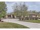 Stunning single-story home with a large driveway and mature landscaping on an overcast day at 2035 Buchanan Pt, Lafayette, CO 80026