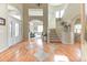Grand foyer with hardwood floors, a curved staircase, and a view into the living room at 2035 Buchanan Pt, Lafayette, CO 80026