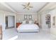 Spacious main bedroom featuring a tray ceiling, fan, built-in shelves, and ensuite access at 2035 Buchanan Pt, Lafayette, CO 80026