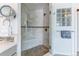 Luxurious tiled shower with built-in bench, rainfall showerhead, and glass block window at 2035 Buchanan Pt, Lafayette, CO 80026