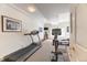 Well-equipped workout room with a treadmill, stationary bike, and natural light from the windows at 2035 Buchanan Pt, Lafayette, CO 80026