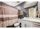 Cozy bathroom featuring a shower with patterned curtain, large mirror and white vanity with sink at 765 N Shawnee St, Aurora, CO 80018