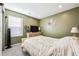 Calming bedroom showcasing an olive-green wall, neutral furnishings, and a window for natural light at 765 N Shawnee St, Aurora, CO 80018
