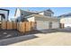 Exterior view of a home featuring a two-car garage and nice landscaping at 765 N Shawnee St, Aurora, CO 80018