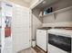 Convenient laundry room featuring a full-size washer and dryer, shelving, and tile flooring at 765 N Shawnee St, Aurora, CO 80018