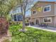 Large backyard with mature trees, a manicured lawn, a patio with outdoor seating and a grill at 13358 Briarwood Dr, Broomfield, CO 80020