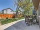 Spacious backyard featuring a patio with outdoor seating, lush lawn, and mature trees at 13358 Briarwood Dr, Broomfield, CO 80020