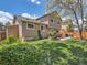 View of the backyard with patio, grill, lawn, privacy fence, and mature landscaping at 13358 Briarwood Dr, Broomfield, CO 80020
