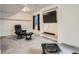 Finished basement with comfortable seating, a wall-mounted TV, and soft carpet at 13358 Briarwood Dr, Broomfield, CO 80020
