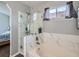 Updated bathroom featuring a soaking tub and glass enclosed shower at 13358 Briarwood Dr, Broomfield, CO 80020