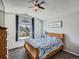 Comfortable bedroom with a ceiling fan and large window with a view at 13358 Briarwood Dr, Broomfield, CO 80020