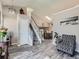 Inviting entryway with stairs, light wood-look floors, and a view into the dining room at 13358 Briarwood Dr, Broomfield, CO 80020