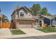 View of a two-story home with a green lawn and a driveway in a residential area at 13358 Briarwood Dr, Broomfield, CO 80020