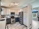 Stylish kitchen with stainless steel appliances, two-tone cabinets, and a unique lighting fixture at 13358 Briarwood Dr, Broomfield, CO 80020