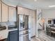 Bright kitchen featuring stainless steel appliances and stylish gray cabinetry at 13358 Briarwood Dr, Broomfield, CO 80020