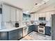 Modern kitchen featuring two-tone cabinets, white countertops and stainless steel appliances at 13358 Briarwood Dr, Broomfield, CO 80020