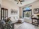 Bright living room featuring a comfortable sofa, decorative shelving and a large arch window at 13358 Briarwood Dr, Broomfield, CO 80020