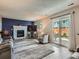 Comfortable living room with a fireplace, a TV, a sliding glass door to the backyard and wood floors at 13358 Briarwood Dr, Broomfield, CO 80020