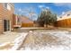 A backyard with trees, a partial patio, a retaining wall, and a shed at 2888 S Fundy St, Aurora, CO 80013