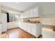 Kitchen featuring white cabinets, hardwood floors, and large countertop space at 2888 S Fundy St, Aurora, CO 80013