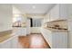 Kitchen featuring white cabinets, hardwood floors, and ample counter space at 2888 S Fundy St, Aurora, CO 80013