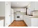 Bright kitchen with white cabinets, hardwood floors, and essential appliances at 2888 S Fundy St, Aurora, CO 80013