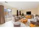 Cozy living room with neutral tones, comfortable seating, and a sliding door leading to the backyard at 2888 S Fundy St, Aurora, CO 80013