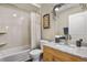 Bathroom featuring a granite vanity top, framed mirror and shower with a tub at 8617 Gold Peak Dr # D, Highlands Ranch, CO 80130