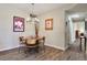 Dining room featuring unique light fixture, artwork, and wood-look floors at 8617 Gold Peak Dr # D, Highlands Ranch, CO 80130