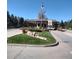 Community entrance with a guard house, flagpole, landscaping, and a private property sign at 8617 Gold Peak Dr # D, Highlands Ranch, CO 80130