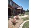 Landscaped walkway leads to townhomes with stone accents, gardens, and well-maintained lawns at 8617 Gold Peak Dr # D, Highlands Ranch, CO 80130