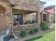 Townhome front porch with brick accents, sliding door, and flowering plants offer a cozy entrance at 8617 Gold Peak Dr # D, Highlands Ranch, CO 80130