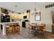 Bright kitchen featuring light wood cabinets, modern appliances, and a cozy dining area with a unique chandelier at 8617 Gold Peak Dr # D, Highlands Ranch, CO 80130