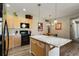 Kitchen island with wood cabinets and stainless appliances at 8617 Gold Peak Dr # D, Highlands Ranch, CO 80130