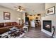 Cozy living room with a fireplace, leather sofa, and open floor plan at 8617 Gold Peak Dr # D, Highlands Ranch, CO 80130