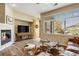 Bright living room featuring a fireplace, large window and modern furnishings at 8617 Gold Peak Dr # D, Highlands Ranch, CO 80130