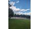 Community tennis courts surrounded by green grass and trees under a blue sky at 8617 Gold Peak Dr # D, Highlands Ranch, CO 80130