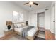 Bedroom with a ceiling fan, wood-look floors, closet with sliding doors, and neutral walls at 1830 Newland Ct # 319, Lakewood, CO 80214