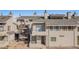 Exterior view of a multi-story townhouse showcasing balconies, stairs, and manicured grounds at 1830 Newland Ct # 319, Lakewood, CO 80214