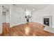 Living room featuring hardwood floors, fireplace, and an open layout to the dining area and modern kitchen at 1830 Newland Ct # 319, Lakewood, CO 80214