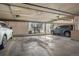 Spacious parking garage featuring two cars and stairs to the units above at 1830 Newland Ct # 319, Lakewood, CO 80214